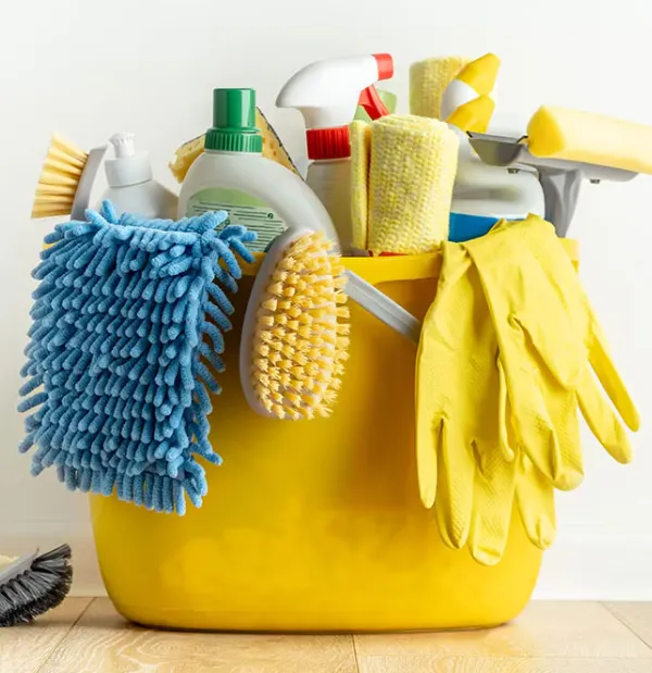 A cleaning bucket full of cleaning products and supplies.