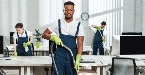 The professional cleaning of an office by a group of cleaners.